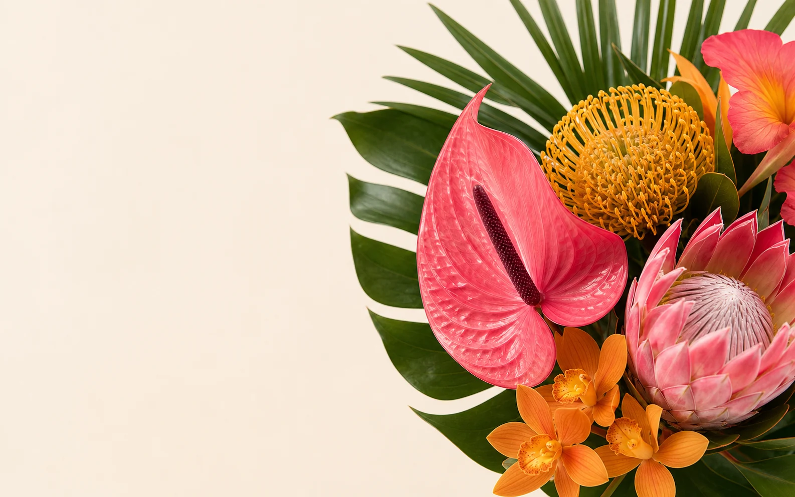 Pink anthurium, protea, golden orchids, and tropical greenery