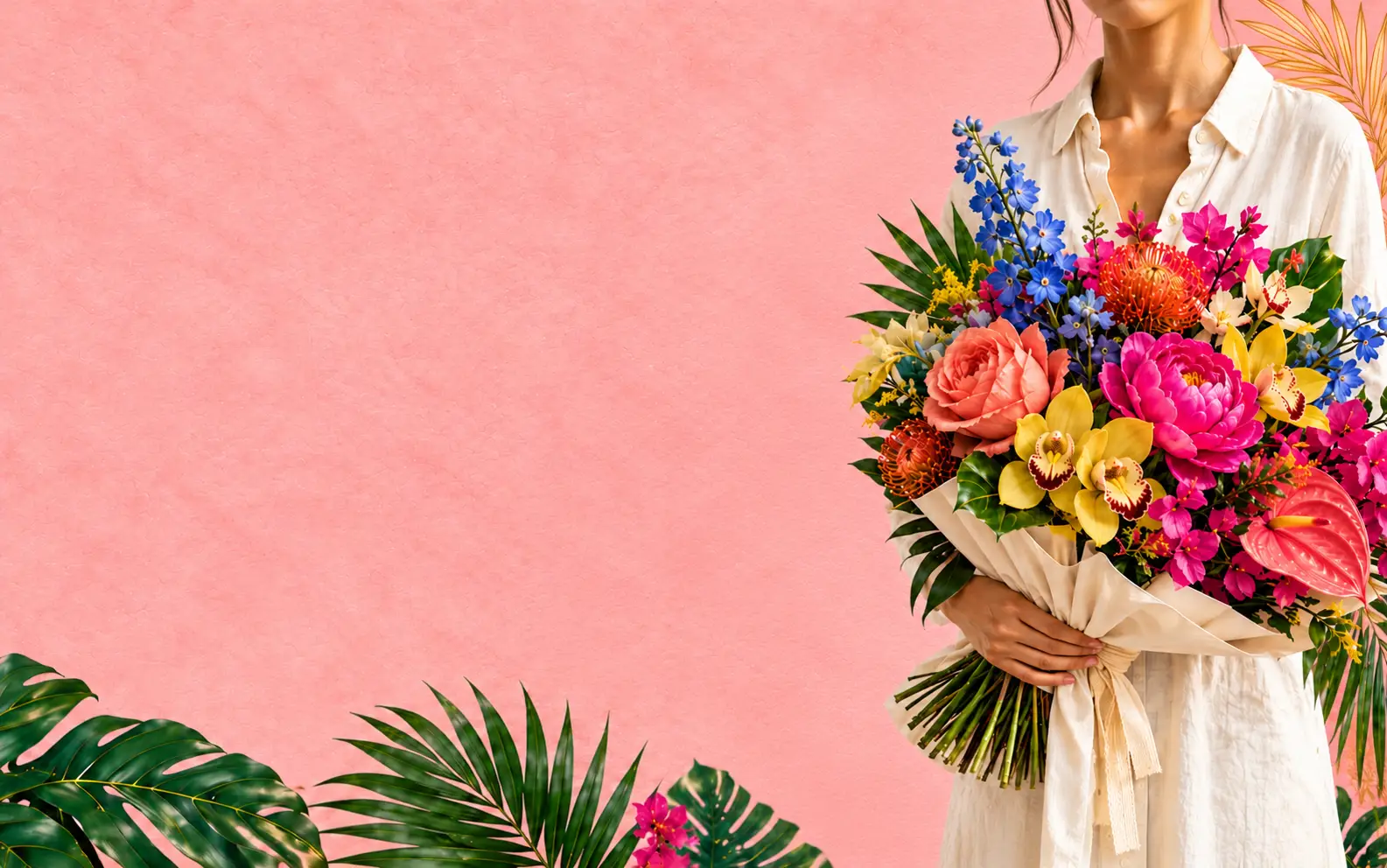 A person in cream linen holding a colorful wrapped bouquet against pink paper, tropical leaves, and gold palm linework