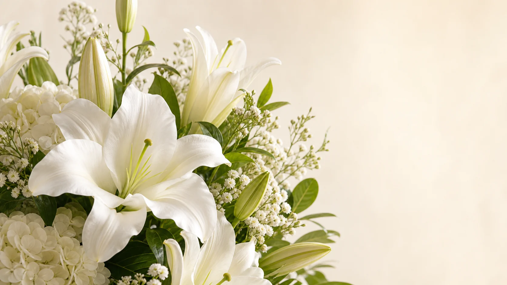 White lilies and hydrangea arranged with fresh greenery