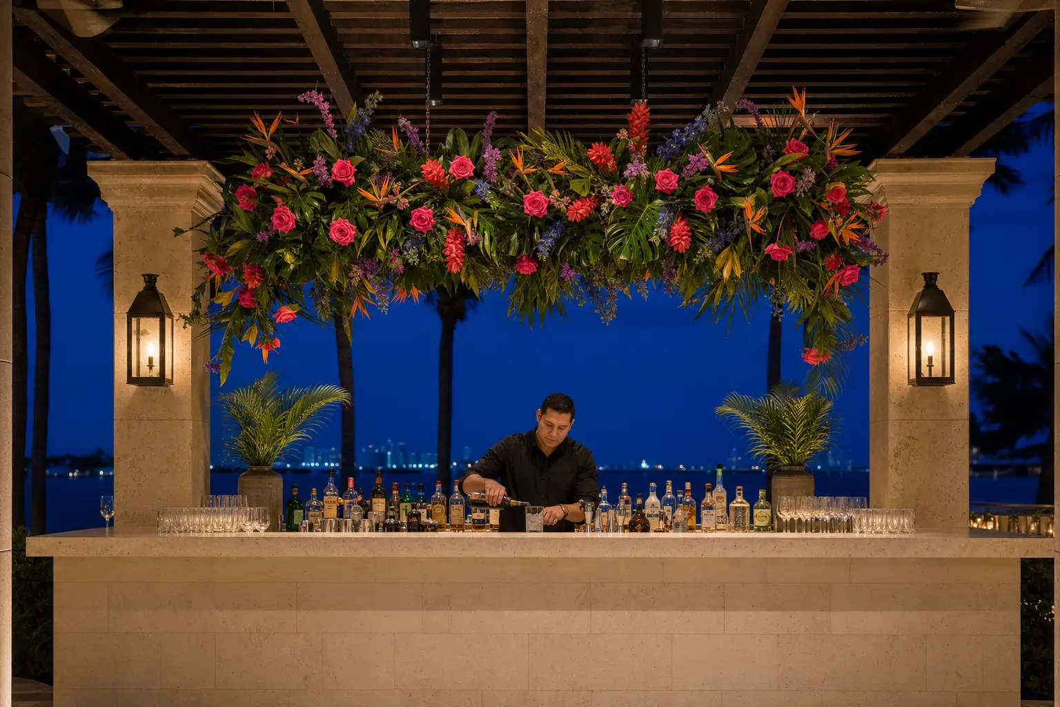 A florist-designed tropical floral canopy above an open South Florida wedding bar